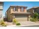 Two story home with red shutters and a tan colored garage at 10352 Rye Patch Creek St, Las Vegas, NV 89141