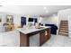Open-concept living area with kitchen island, dark cabinets, and a view of the living and dining spaces at 10352 Rye Patch Creek St, Las Vegas, NV 89141