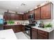 Kitchen with dark cabinets, stainless steel appliances, white countertops and open layout provides a welcoming space at 10352 Rye Patch Creek St, Las Vegas, NV 89141