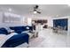 Open-concept living room showcasing modern décor, a large sofa, and a dining area at 10352 Rye Patch Creek St, Las Vegas, NV 89141