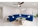 Stylish living room featuring a large blue sectional sofa, and elegant decor at 10352 Rye Patch Creek St, Las Vegas, NV 89141