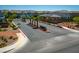 A street view of the neighborhood entrance with palm trees and attractive landscaping at 10352 Rye Patch Creek St, Las Vegas, NV 89141
