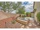 Backyard features a sunken hot tub, partial privacy walls, and low maintenance landscaping at 10513 Bandera Mountain Ln, Las Vegas, NV 89166