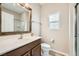 Bathroom with a wood framed mirror, wood cabinets, and a separate walk-in shower at 10513 Bandera Mountain Ln, Las Vegas, NV 89166