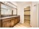 Bathroom featuring double sinks, framed mirrors, and a walk-in closet at 10513 Bandera Mountain Ln, Las Vegas, NV 89166
