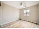 Comfortable bedroom with wood-look flooring, ceiling fan, and bright window at 10513 Bandera Mountain Ln, Las Vegas, NV 89166