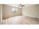 Spacious bedroom with a ceiling fan, large window for natural light and light wood flooring at 10513 Bandera Mountain Ln, Las Vegas, NV 89166
