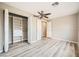 Bright bedroom with wood-look floors and closet with shelves, drawers, and hanging rods at 10513 Bandera Mountain Ln, Las Vegas, NV 89166