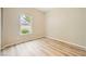 Bright bedroom with a large window letting in natural light and light wood flooring throughout at 10513 Bandera Mountain Ln, Las Vegas, NV 89166