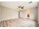 Large bedroom with a ceiling fan and light wood floors leading to an ensuite bathroom at 10513 Bandera Mountain Ln, Las Vegas, NV 89166