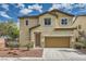 Inviting two-story home featuring a cozy landscape, neutral stucco, and a convenient two-car garage with brown door at 10513 Bandera Mountain Ln, Las Vegas, NV 89166
