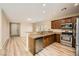 Modern kitchen with granite countertops, stainless steel appliances, wood cabinets, and open layout at 10513 Bandera Mountain Ln, Las Vegas, NV 89166