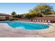 Sparkling community pool surrounded by lounge chairs and lush landscaping, perfect for relaxation at 10513 Bandera Mountain Ln, Las Vegas, NV 89166