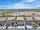 Aerial view of a neighborhood showcasing well-maintained homes with tile roofs and desert landscaping under a sunny sky at 10613 Turquoise Valley Dr, Las Vegas, NV 89144