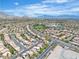 High angle showcases a residential neighborhood with landscaped streets and picturesque mountains at 10613 Turquoise Valley Dr, Las Vegas, NV 89144
