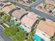 Aerial view of multiple houses, each with a private backyard pool, surrounded by green trees at 10613 Turquoise Valley Dr, Las Vegas, NV 89144