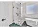Bathroom features glass shower, soaking tub, and black hexagon tiled flooring at 10613 Turquoise Valley Dr, Las Vegas, NV 89144