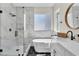Modern bathroom with glass enclosed shower, soaking tub, double sink, and black hexagonal tile floor at 10613 Turquoise Valley Dr, Las Vegas, NV 89144