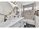 Bathroom with dual sinks, marble countertops, modern lighting and tile at 10613 Turquoise Valley Dr, Las Vegas, NV 89144