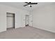 Bedroom with carpet, ceiling fan, and closet with sliding doors at 10613 Turquoise Valley Dr, Las Vegas, NV 89144