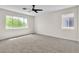 Spacious bedroom with two windows, neutral carpet, and white walls at 10613 Turquoise Valley Dr, Las Vegas, NV 89144