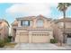 Charming two-story home with a two-car garage, lush landscaping, and inviting curb appeal at 10613 Turquoise Valley Dr, Las Vegas, NV 89144