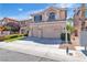 Two-story home with a two-car garage, a well-kept lawn, and mature landscaping at 10613 Turquoise Valley Dr, Las Vegas, NV 89144