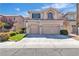 Two-story home with a two-car garage, a well-kept lawn, and mature landscaping at 10613 Turquoise Valley Dr, Las Vegas, NV 89144
