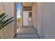 Inviting front porch with a white door, sidelight window, and shade at 10613 Turquoise Valley Dr, Las Vegas, NV 89144
