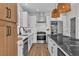 Beautiful kitchen with white cabinets, stainless steel appliances, and black marble island at 10613 Turquoise Valley Dr, Las Vegas, NV 89144