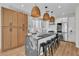 Modern kitchen with stainless steel appliances, island with seating, and stylish pendant lighting at 10613 Turquoise Valley Dr, Las Vegas, NV 89144