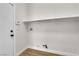 Bright laundry area featuring a shelf, hookups, and durable wood-look flooring at 10613 Turquoise Valley Dr, Las Vegas, NV 89144