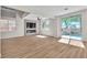 Spacious living room with fireplace, fan, wood floors and access to pool at 10613 Turquoise Valley Dr, Las Vegas, NV 89144