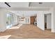Bright living room with wood floors, open floor plan, wine rack, and access to the pool at 10613 Turquoise Valley Dr, Las Vegas, NV 89144