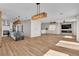 Open floor plan featuring wood floors, modern light fixtures, and seamless flow to the kitchen at 10613 Turquoise Valley Dr, Las Vegas, NV 89144