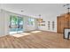 Bright living room with wood floors, open floor plan, wine rack, and pool access at 10613 Turquoise Valley Dr, Las Vegas, NV 89144