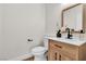 Stylish powder room featuring a wood vanity, black faucet, and modern decor at 10613 Turquoise Valley Dr, Las Vegas, NV 89144