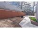 Backyard featuring large concrete patio, xeriscaping, and retaining wall at 110 Wynntry Dr, Henderson, NV 89074