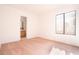 Spacious bedroom features neutral carpet, window, and access to ensuite bathroom at 110 Wynntry Dr, Henderson, NV 89074