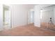 Open bedroom with neutral carpet and doorways to the en-suite bathroom and closets at 110 Wynntry Dr, Henderson, NV 89074