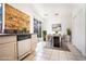 Eat-in kitchen with wood accent wall, stainless appliances, and sliding door to the backyard at 110 Wynntry Dr, Henderson, NV 89074