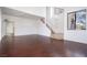 Open living room with dark wood floors, staircase and lots of natural light at 110 Wynntry Dr, Henderson, NV 89074