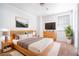 Modern main bedroom with natural wood furniture and decor, and a large window at 110 Wynntry Dr, Henderson, NV 89074