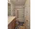 Functional bathroom with combined shower and tub, a wood vanity, and natural light at 1169 Paradise River Rd, Henderson, NV 89002