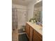 Bathroom featuring double sinks, a bathtub/shower combo, and decorative grey accents at 1169 Paradise River Rd, Henderson, NV 89002