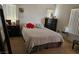 Bright bedroom featuring a bed with striped bedding, side tables, and ample natural light at 1169 Paradise River Rd, Henderson, NV 89002