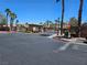 An exterior view of a gated community entrance featuring landscaping, a stop sign, and security booth at 1169 Paradise River Rd, Henderson, NV 89002