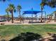 A community park with picnic tables, playground and mature landscaping surrounded by residential homes at 1169 Paradise River Rd, Henderson, NV 89002
