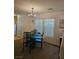 Cozy dining room with modern chandelier and adjacent kitchen at 1169 Paradise River Rd, Henderson, NV 89002