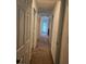 Hallway with neutral colored walls and carpet leading to a bright, light filled room at 1169 Paradise River Rd, Henderson, NV 89002